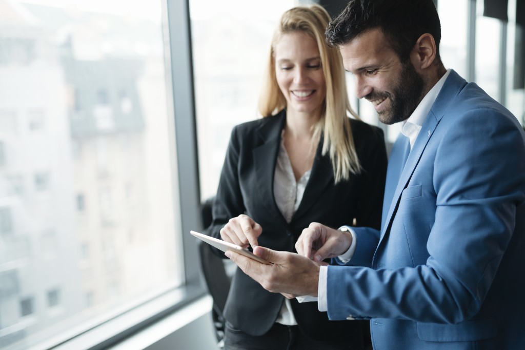 Two Jones Square employees looking over client information relating to outsourced invoice processing services.