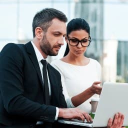 A Jones Square employee assisting a small business owner with outsourced invoice management services